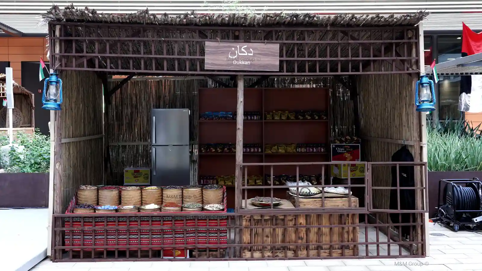 Traditional dukkān display with spice baskets and heritage snacks for flydubai UAE National Day celebration in Dubai