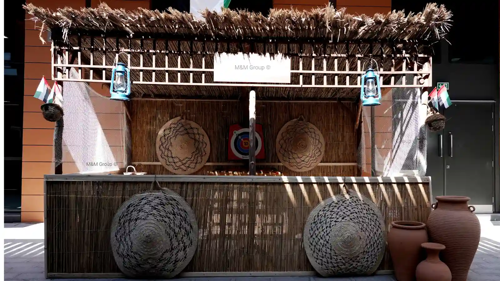 Traditional game booth with areesh structure and UAE flag décor for flydubai UAE National Day celebration in Dubai