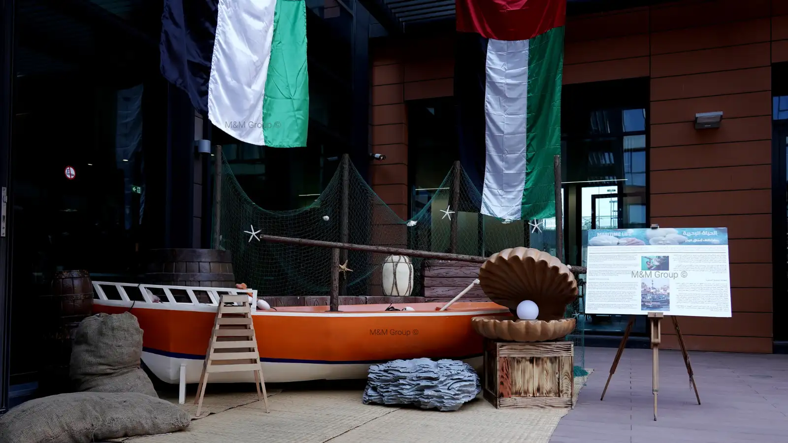 Marine décor with boat, gargoor net, pearl display, and UAE flags for flydubai UAE National Day celebration in Dubai